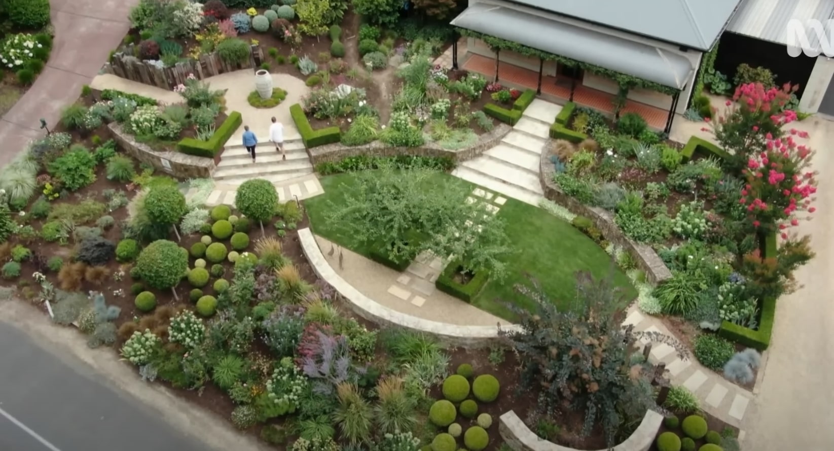 Stunning aerial view of professional landscape design with curved pathways and diverse plantings